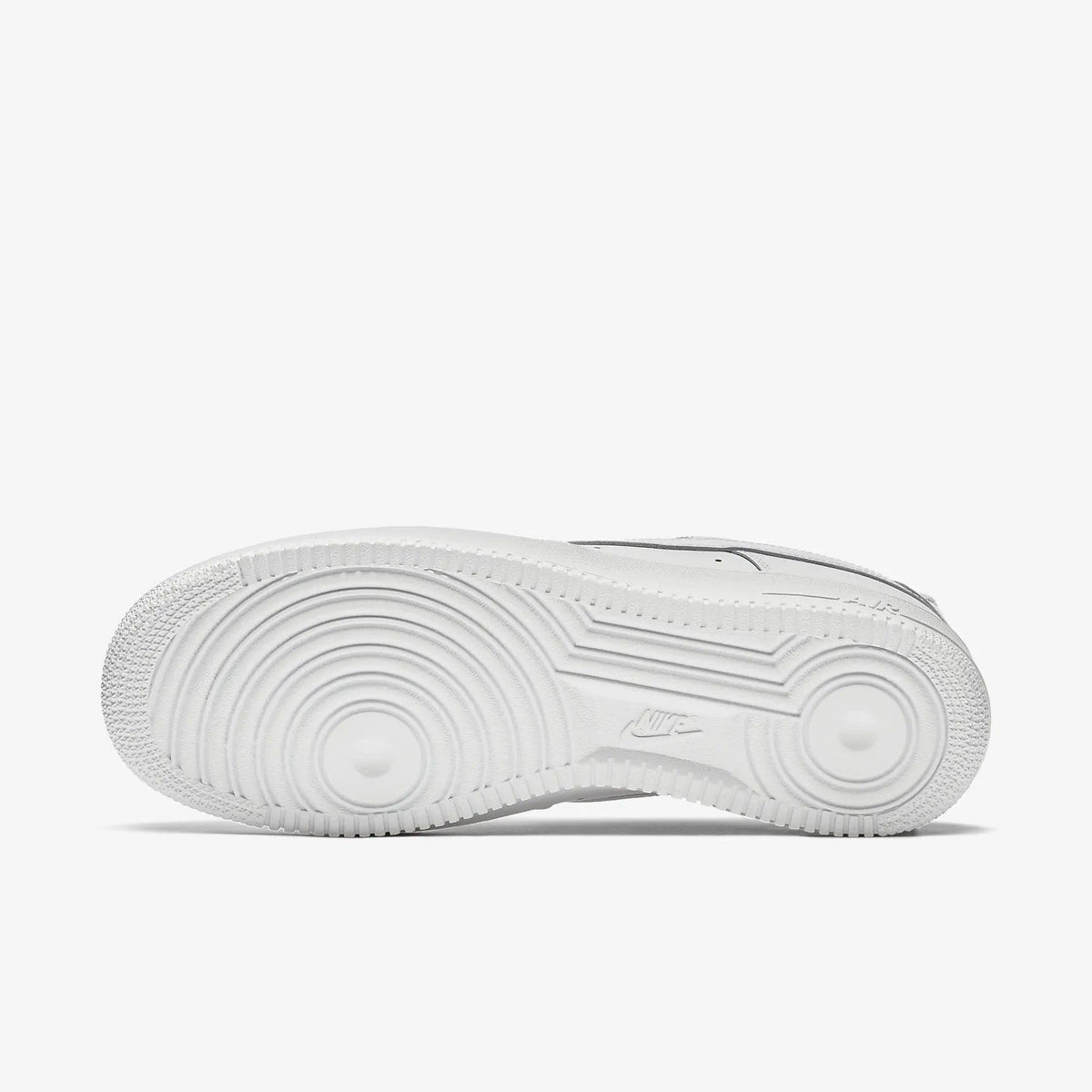 White sneaker outsole with circular traction pattern and Nike branding