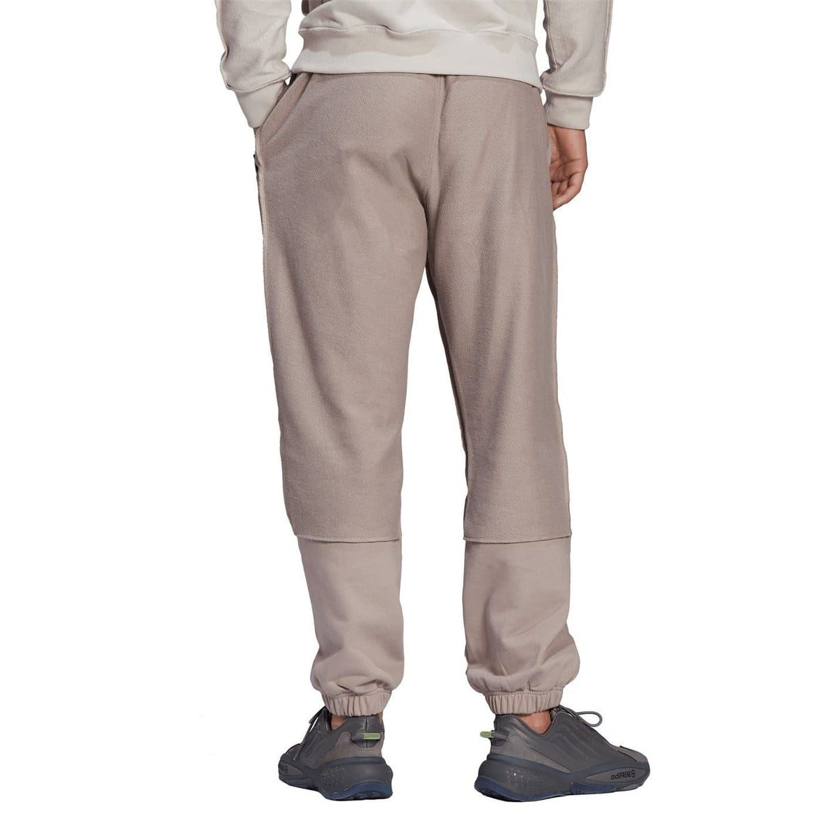 Taupe jogger pants with elastic waist, drawstring, relaxed tapered legs, cuffed hems.