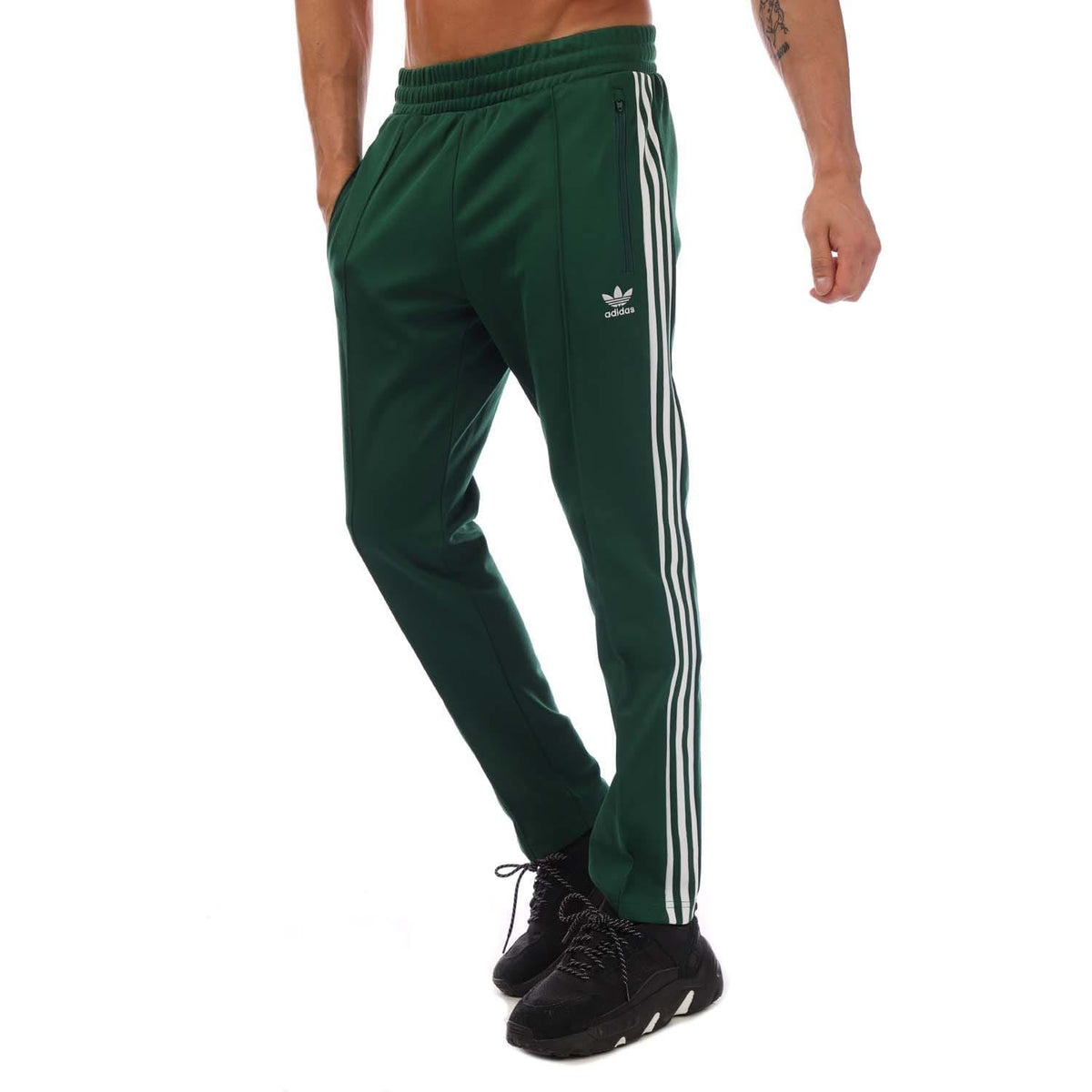 Green track pants with white side stripes and elastic ankle cuffs