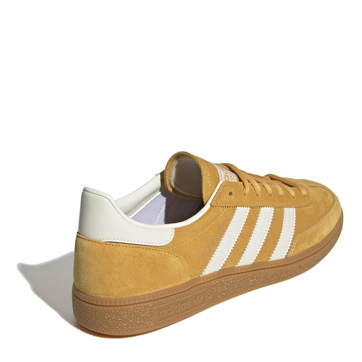 Tan suede low top sneakers from heel angle with white stripes and white inner lining.