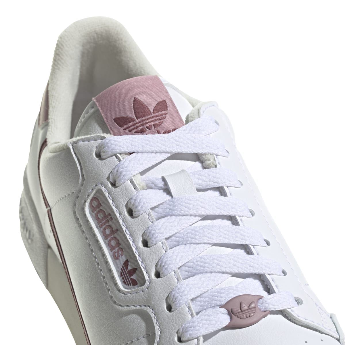 Women's white vegan trainers close-up: lace-up, Adidas label, mauve side logo
