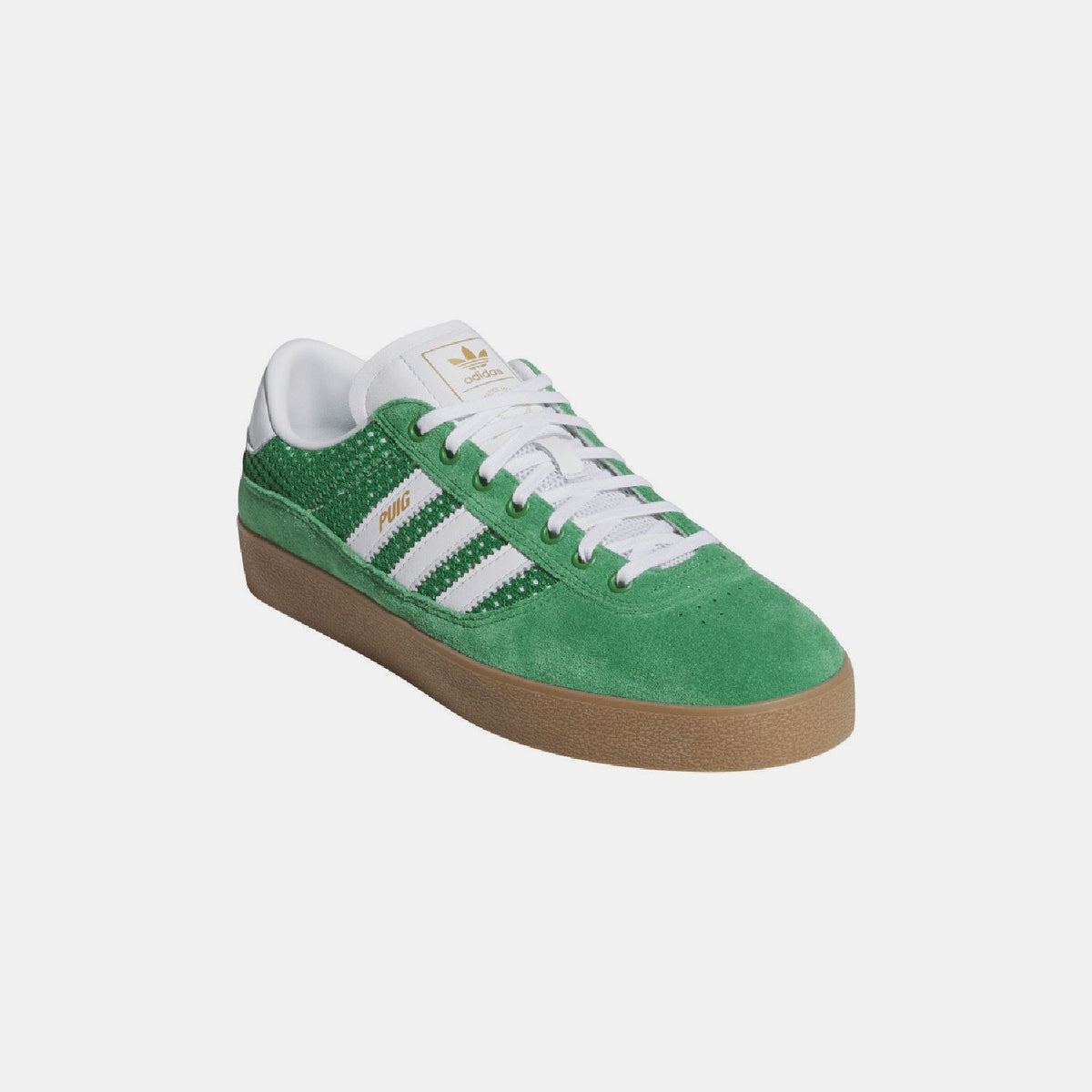 Green adidas indoor trainer with white laces, white heel tab, and gum sole