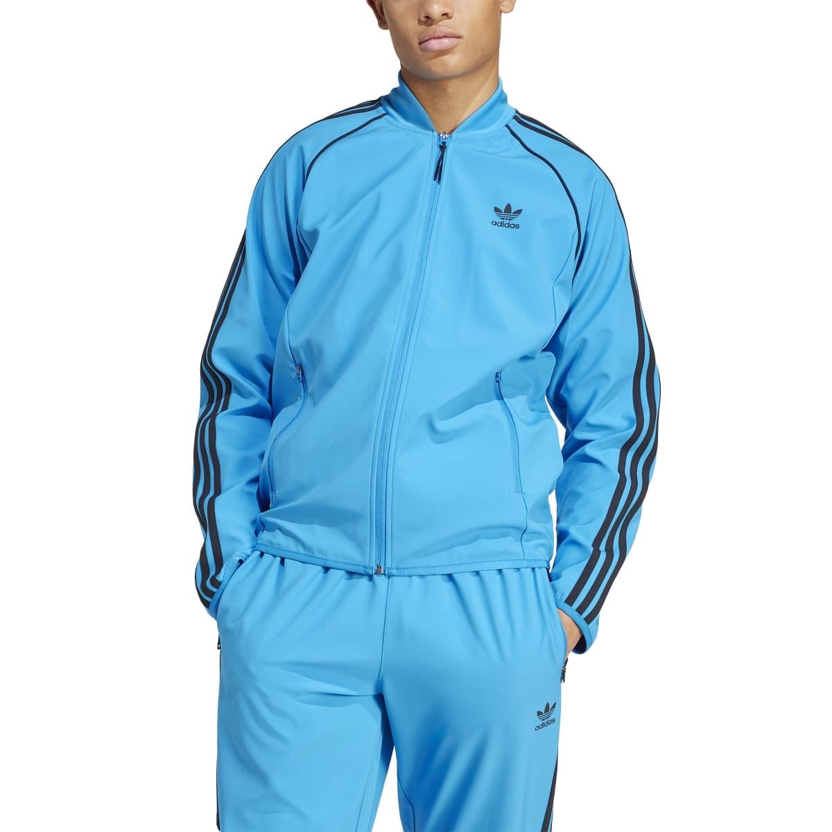 Blue adidas track jacket with full zip and black stripes along shoulders and sleeves