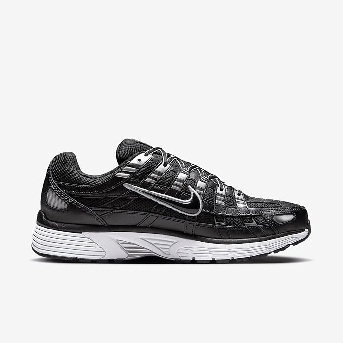 Black Nike lace-up sneakers with silver paneling and white ribbed midsole.