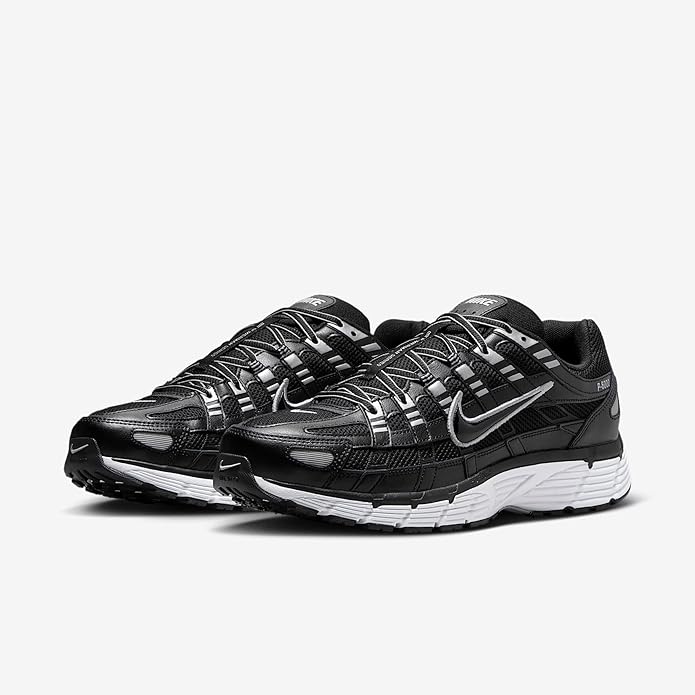 Black athletic sneakers, dual Swoosh and lace-up design with textured straps.