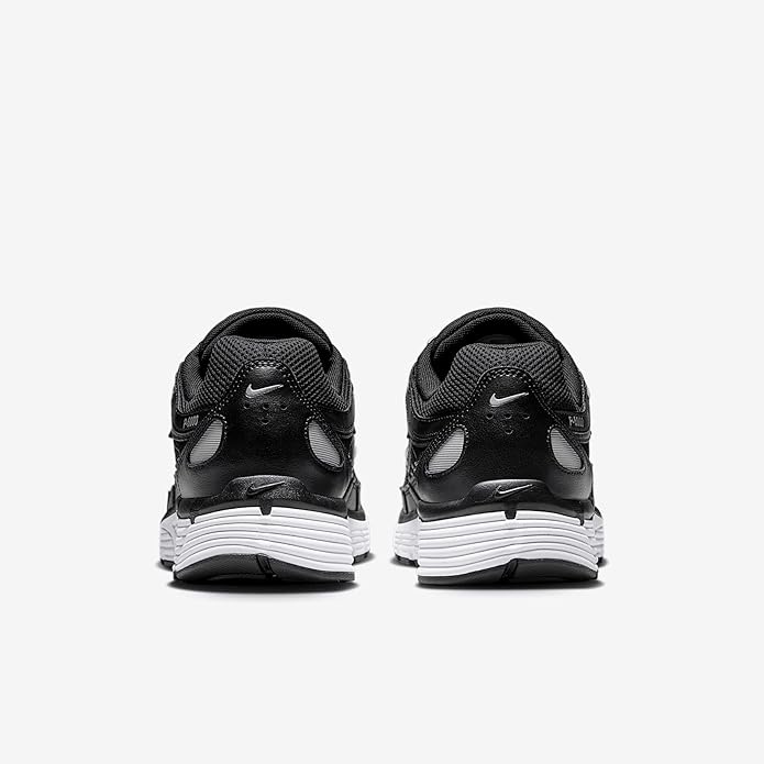 Back view of black Nike sneakers with heel pull tab and cushioned collar.