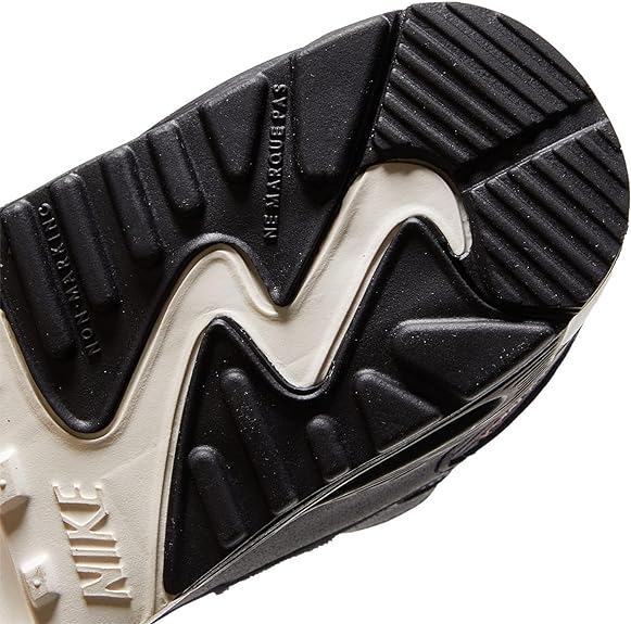 Toddler Nike Air Max 90 LTR outsole close-up, black tread with white midsole edge