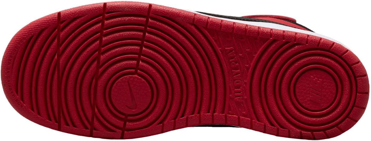 Kids' Nike mid-top sneaker outsole, red tread pattern with circular traction pods