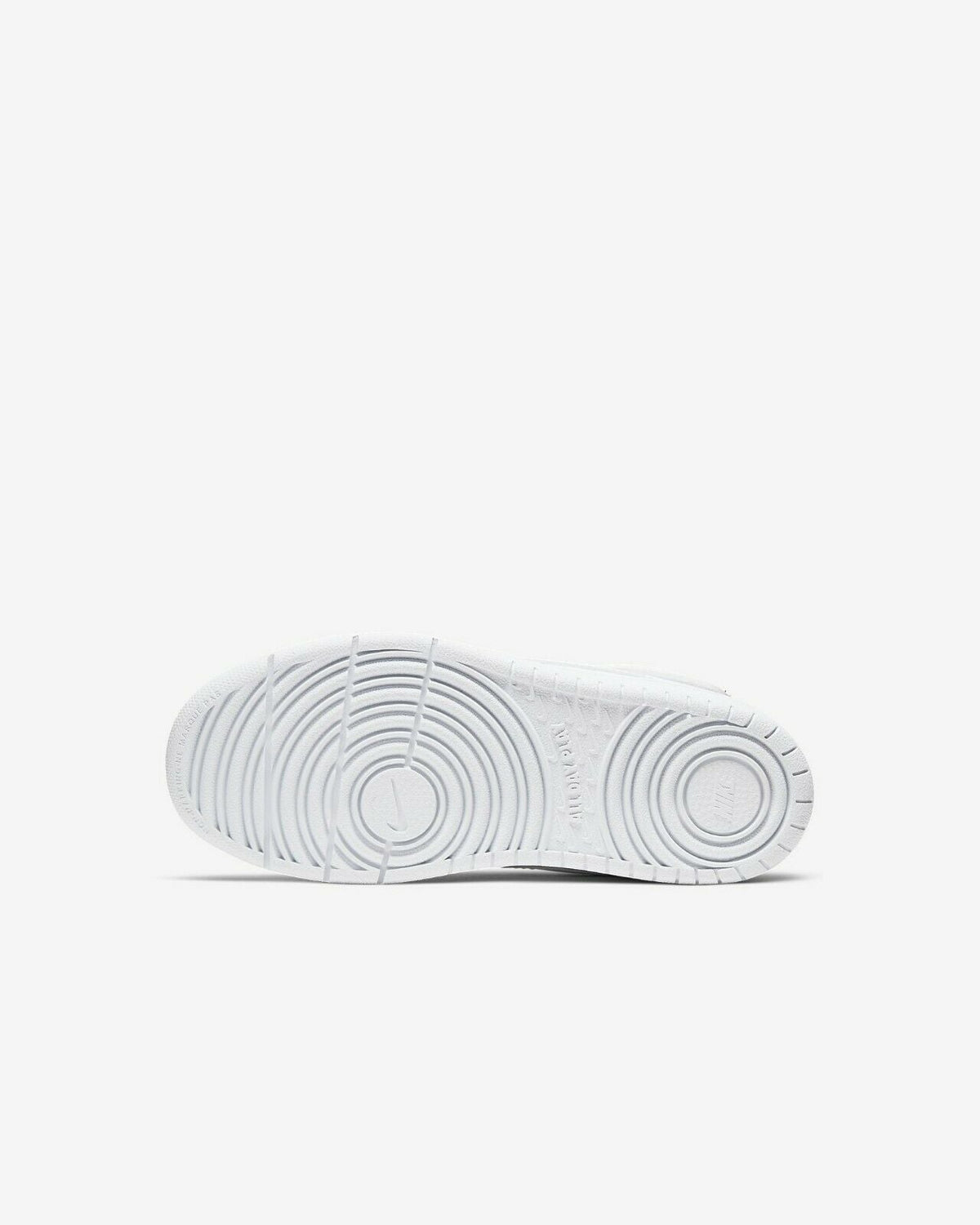 White kids' sneaker outsole with circular tread and ridged grooves