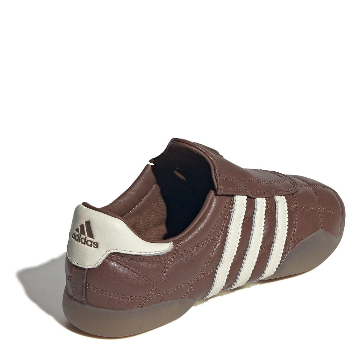 Brown adidas Originals low top sneakers with cream collar and three stripes on side.