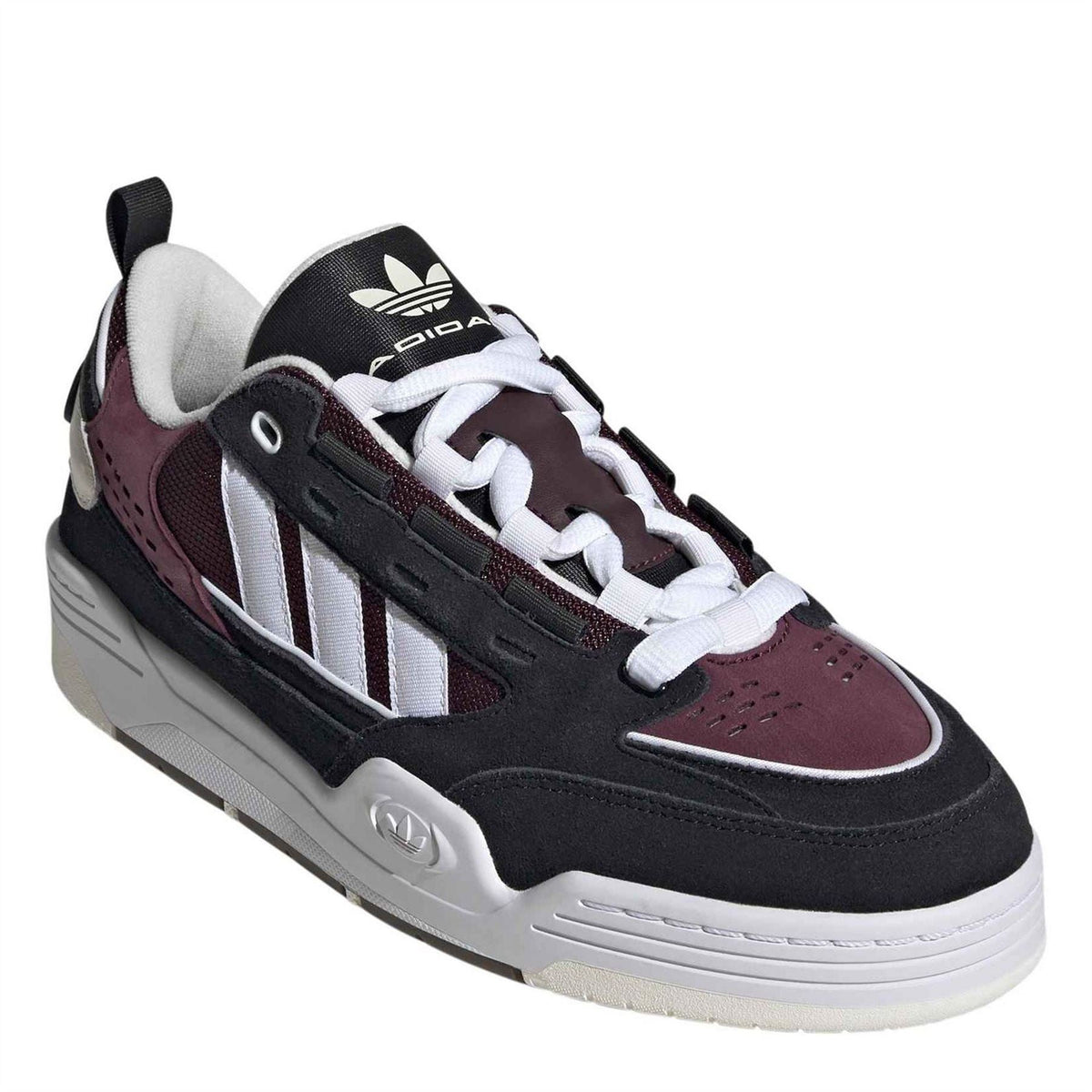 Low-top sneakers with black upper, white three stripes, burgundy panel, lace-up