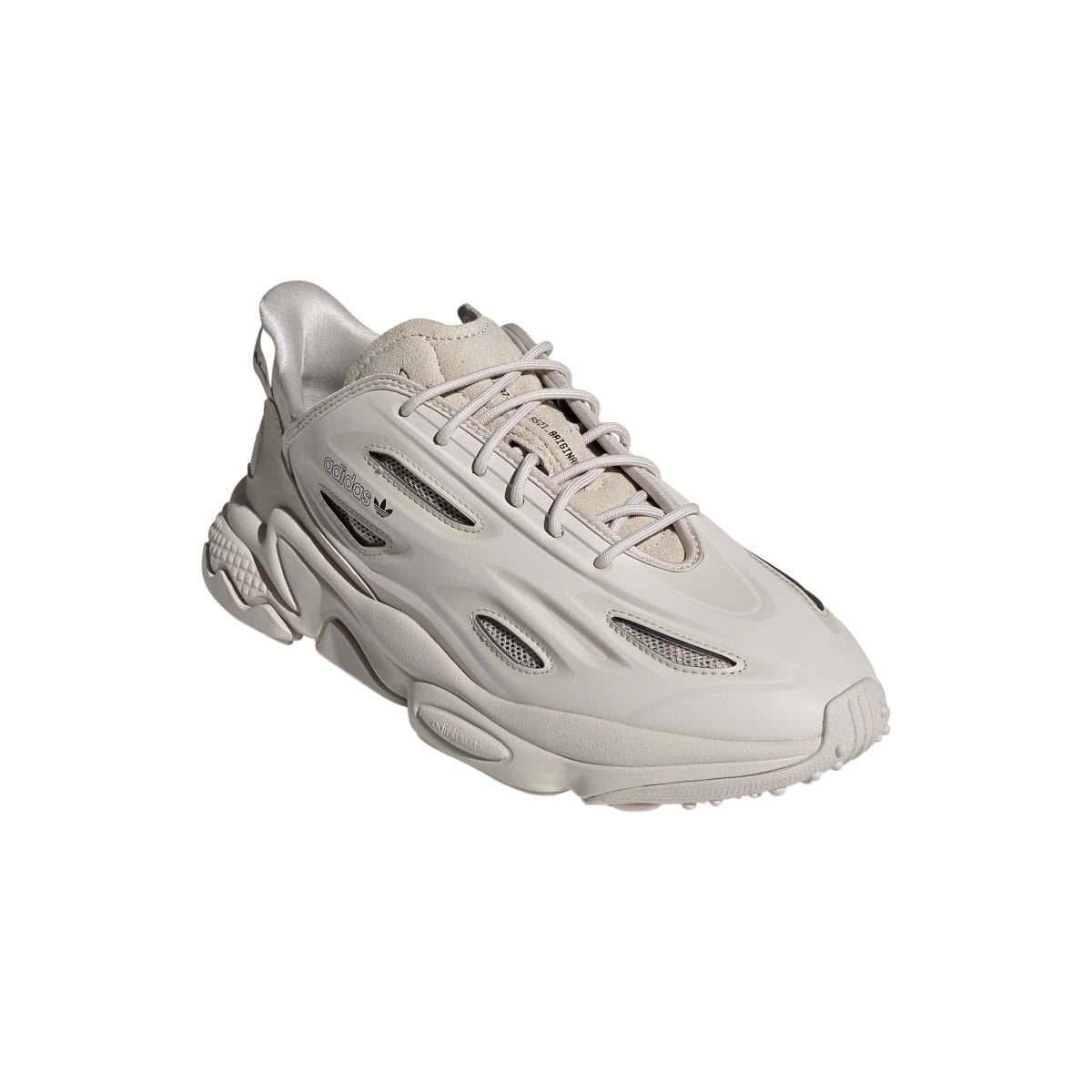 adidas Ozweego trainers angled view in light cream with lace-up top and wavy midsole