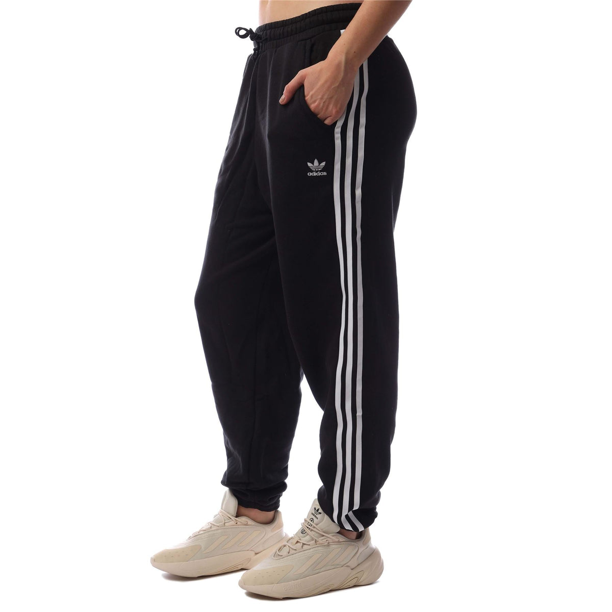 adidas Originals black jogger pants with white side stripes, drawstring waist