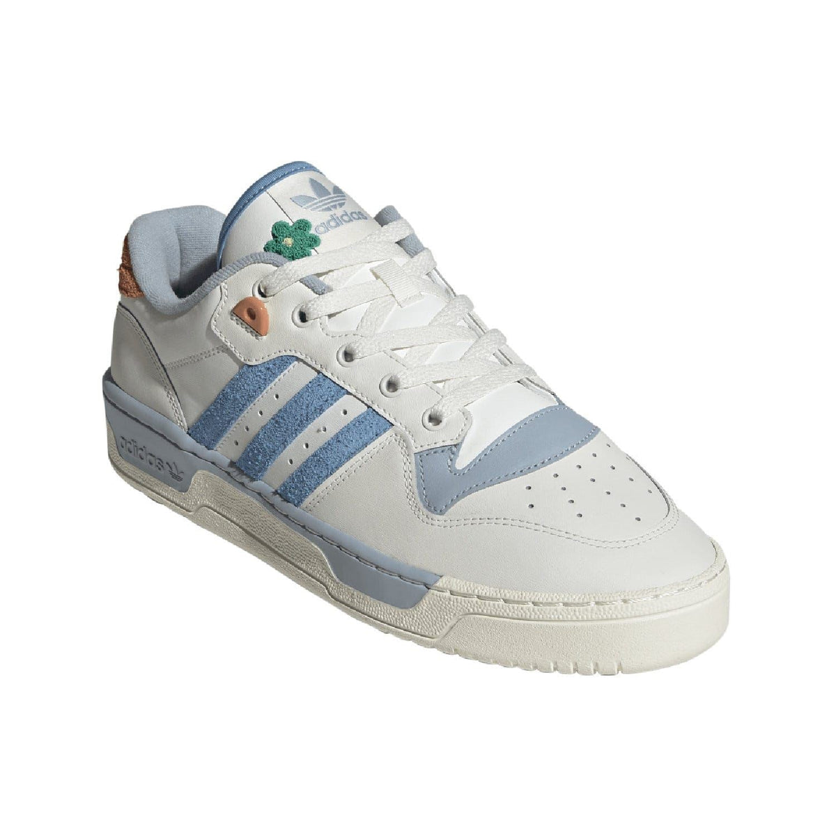 White low-top trainers with blue stripes, gray heel, and green tongue label