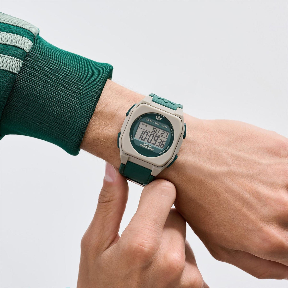 adidas Originals digital watch on wrist, beige case with green resin strap