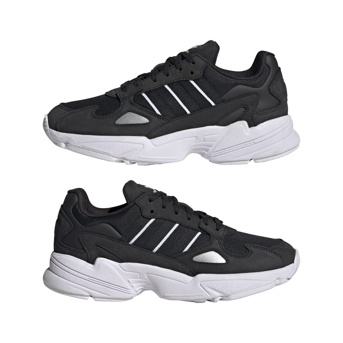Black adidas Falcon trainers, side view, white stripes and cushioned chunky sole