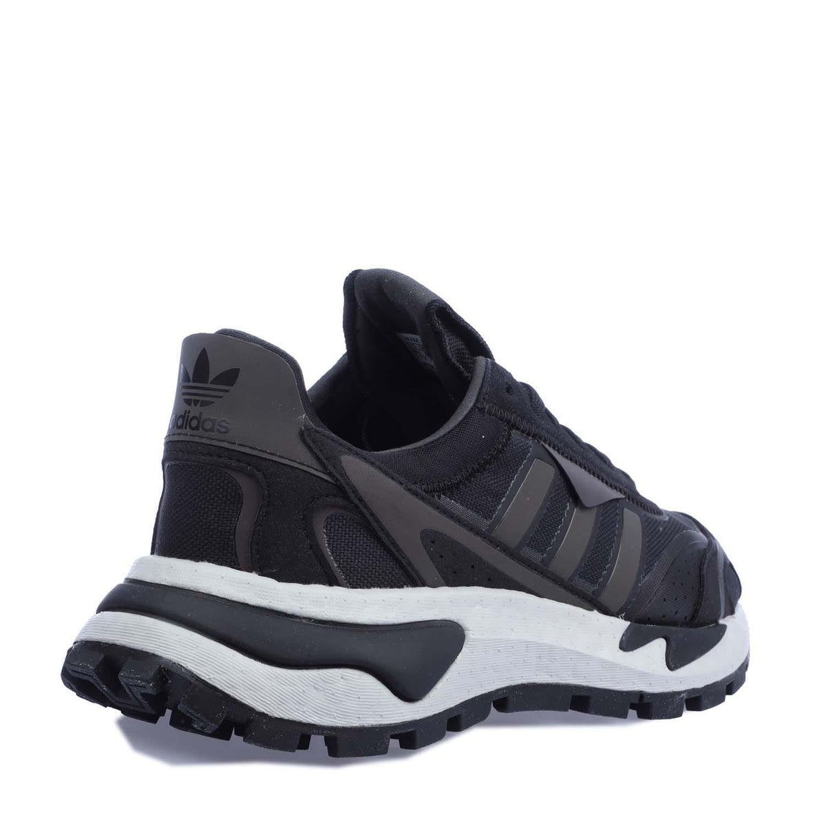 Black trainers viewed from side and heel, showing padded collar and outsole tread.