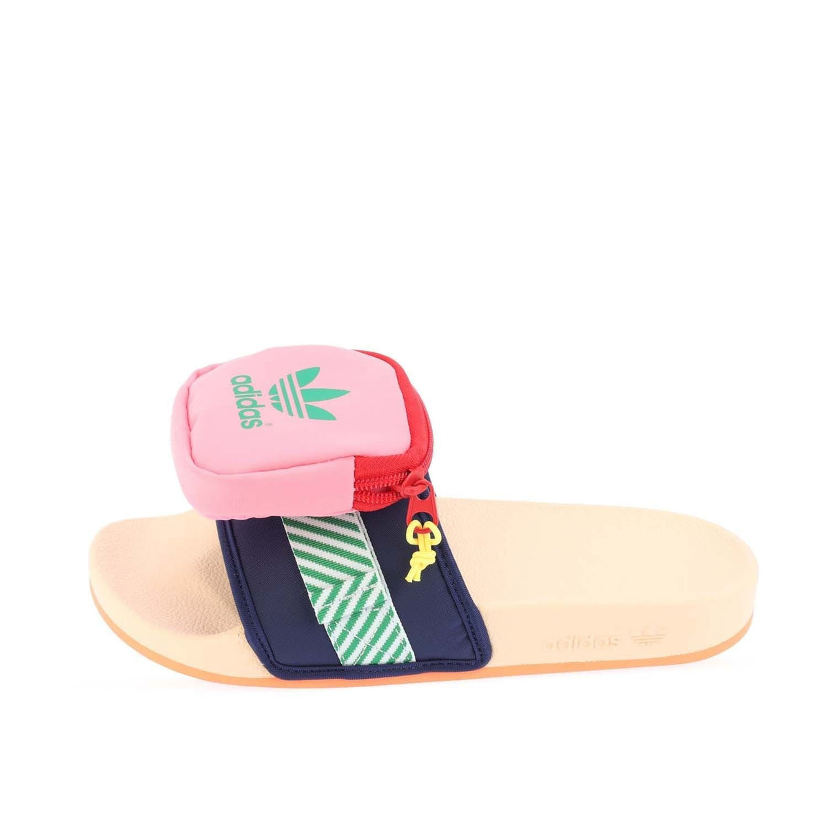 Pink slide sandal with navy strap, green stripes, and red zipper pouch