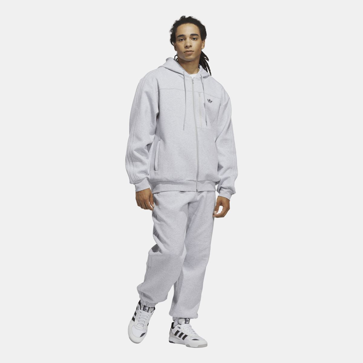 Grey zip fleece hoodie on model, full-body view with hood and chest logo visible.