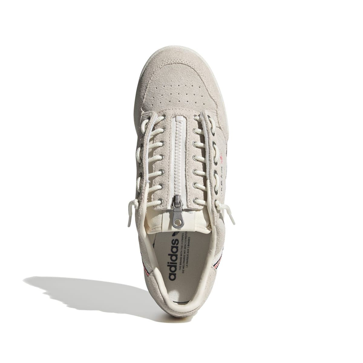 Light beige suede lace-up trainer with perforated toe and padded heel collar