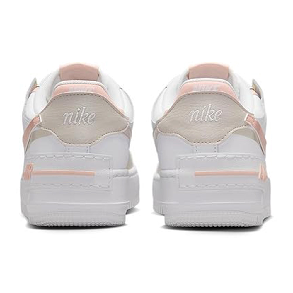 Women's low-top sneakers heel view, with pink lining and Nike logo on back