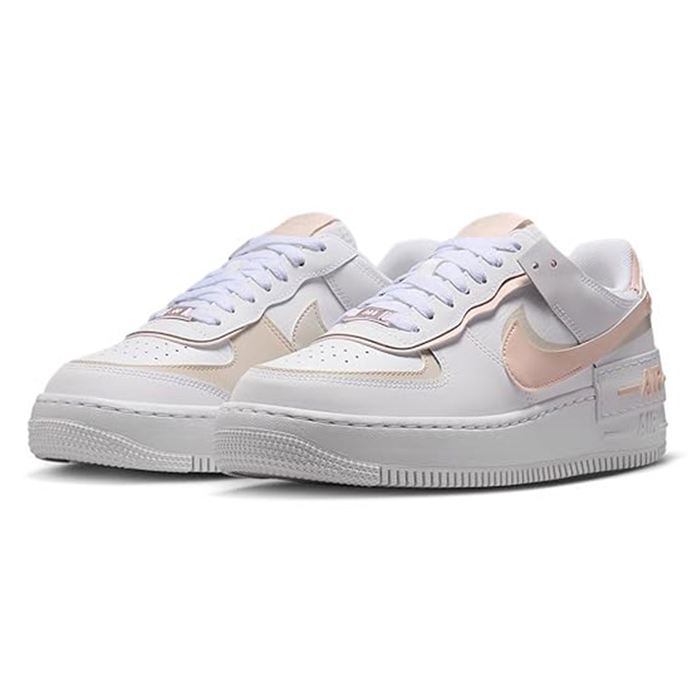 Women's low-top sneakers front angle, white leather with coral-pink accents