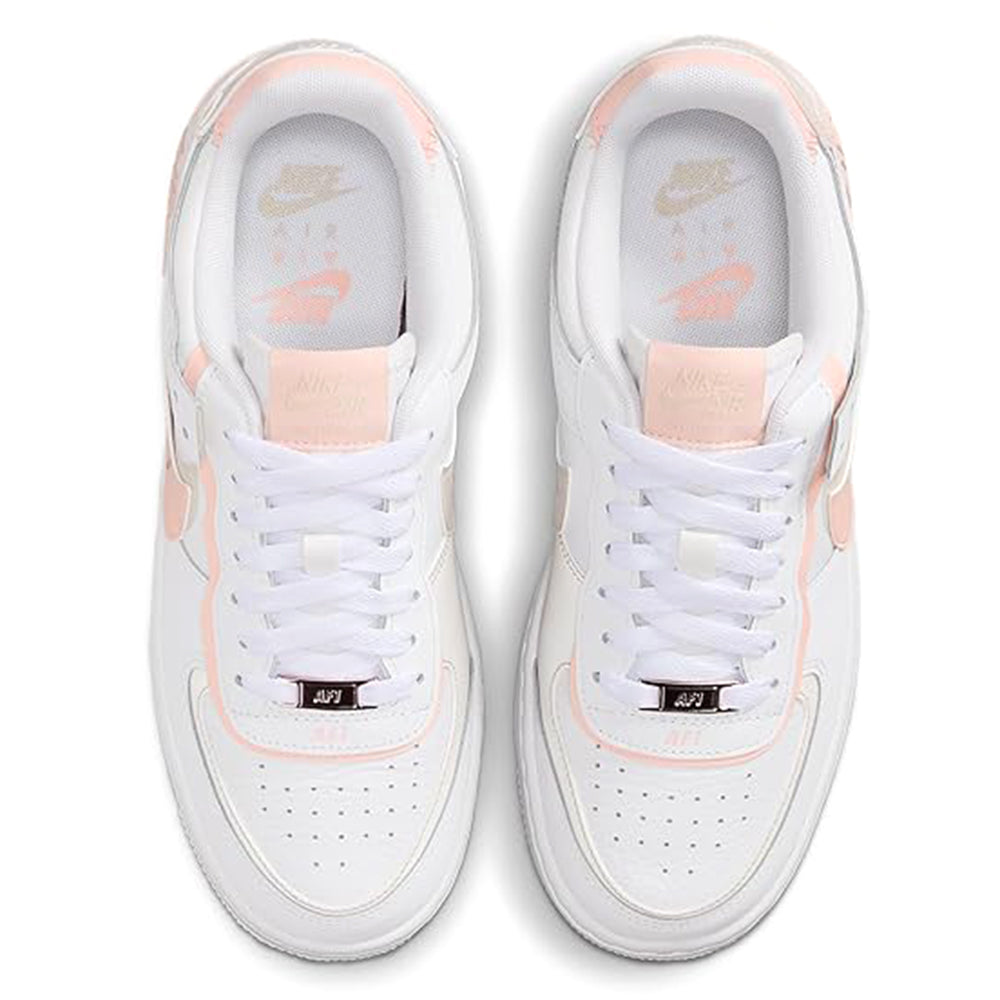 Women's low-top sneakers lace-up view, white uppers with coral-pink heel details