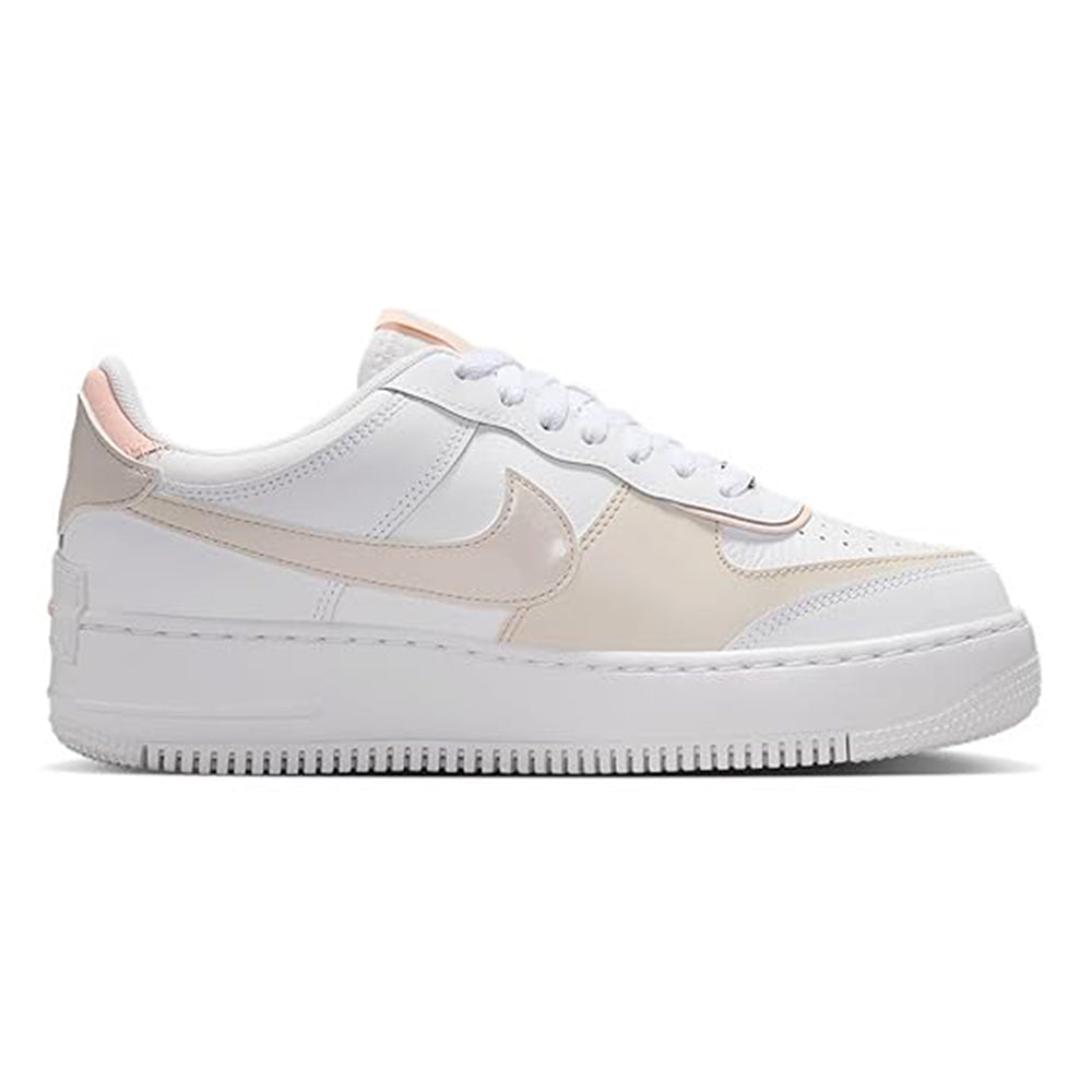 Women's low-top sneakers side view, white leather with coral-pink overlays and laces