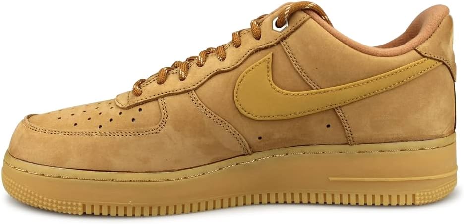 Nike Air Force 1 low-top sneakers with tan suede uppers, lace-up, and gum outsole