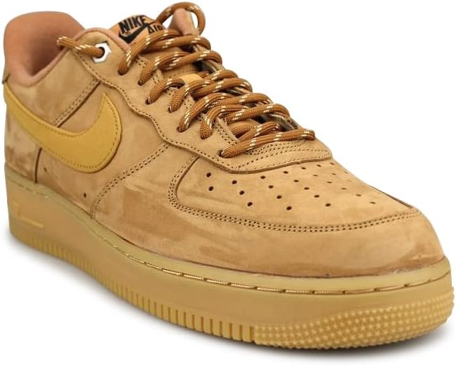 Nike Air Force 1 low-top sneakers in tan suede with lace-up, perforated toe, gum sole