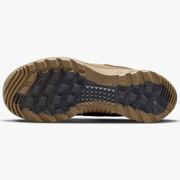 Men's Nike outsole view, rugged tread pattern on tan and dark rubber sole