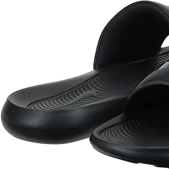 Black Nike slide sandals showing ribbed footbed texture