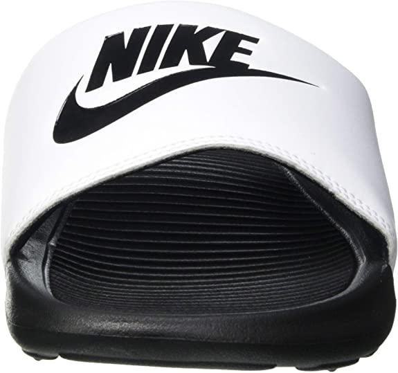 White Nike slide sandal with large black "NIKE" logo and ridged footbed