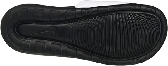 Black Nike slide sandal outsole with textured tread and drainage channels