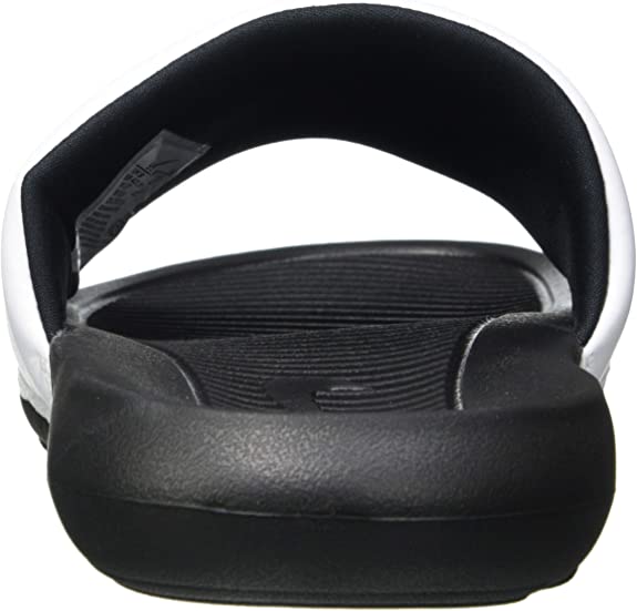 Black and white Nike slide sandal with cushioned strap and textured footbed