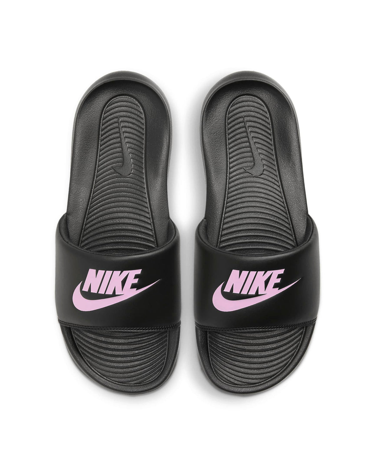 Pair of black slide sandals showing pink Nike branding on foot straps