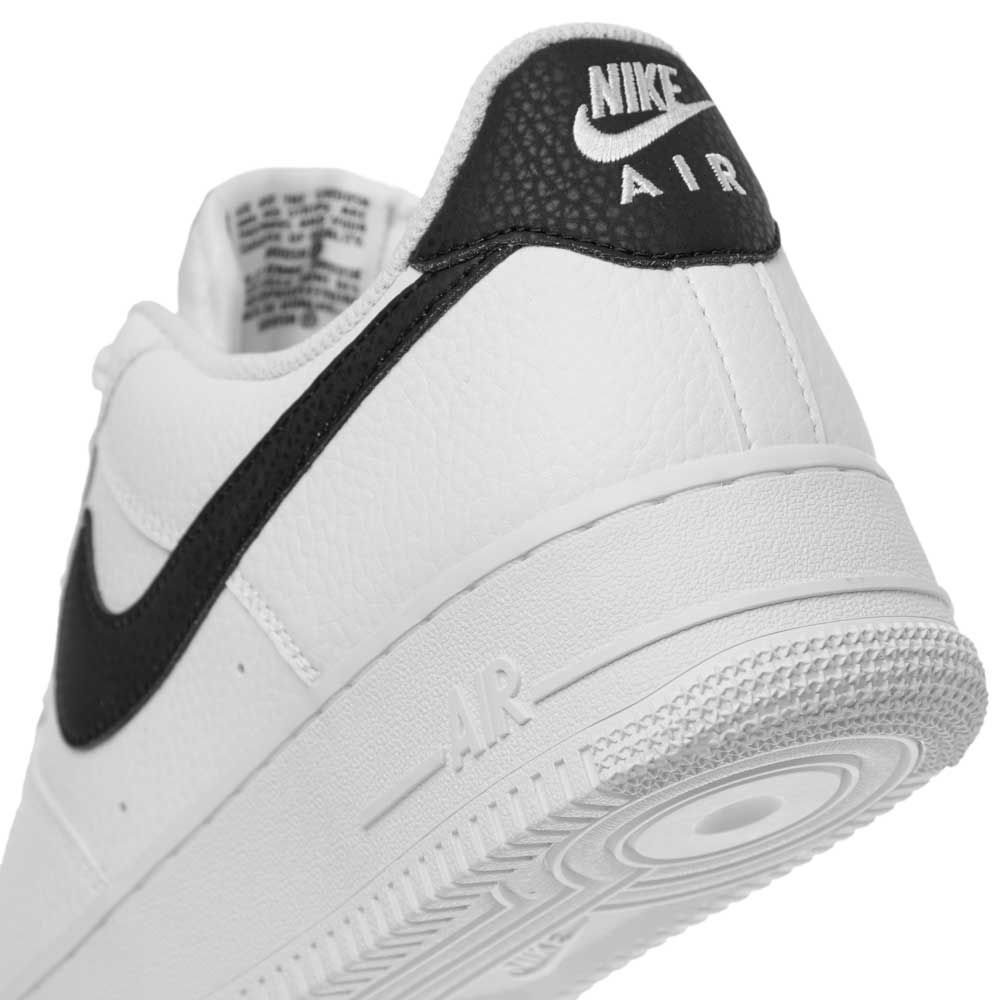 Low-top sneakers heel view with black Swoosh and 'AIR' detail on white upper
