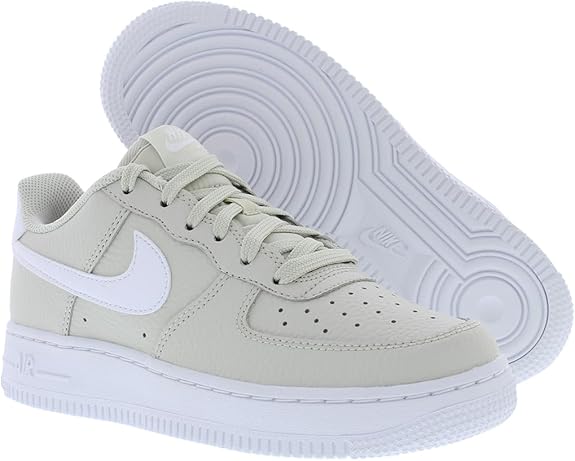Big kids Nike Air Force 1 sneaker with light bone upper and white textured outsole
