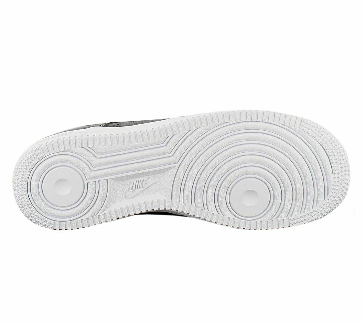 White rubber outsole for kids sneaker with Nike logo and circular traction pattern