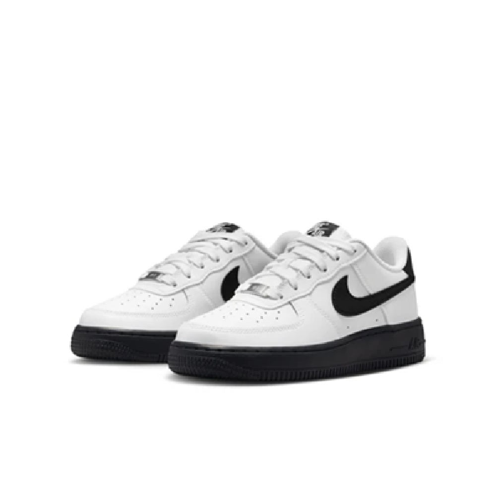 Kids' Nike Air Force 1 low-top sneakers pair, white with black swoosh and lace-up fronts.
