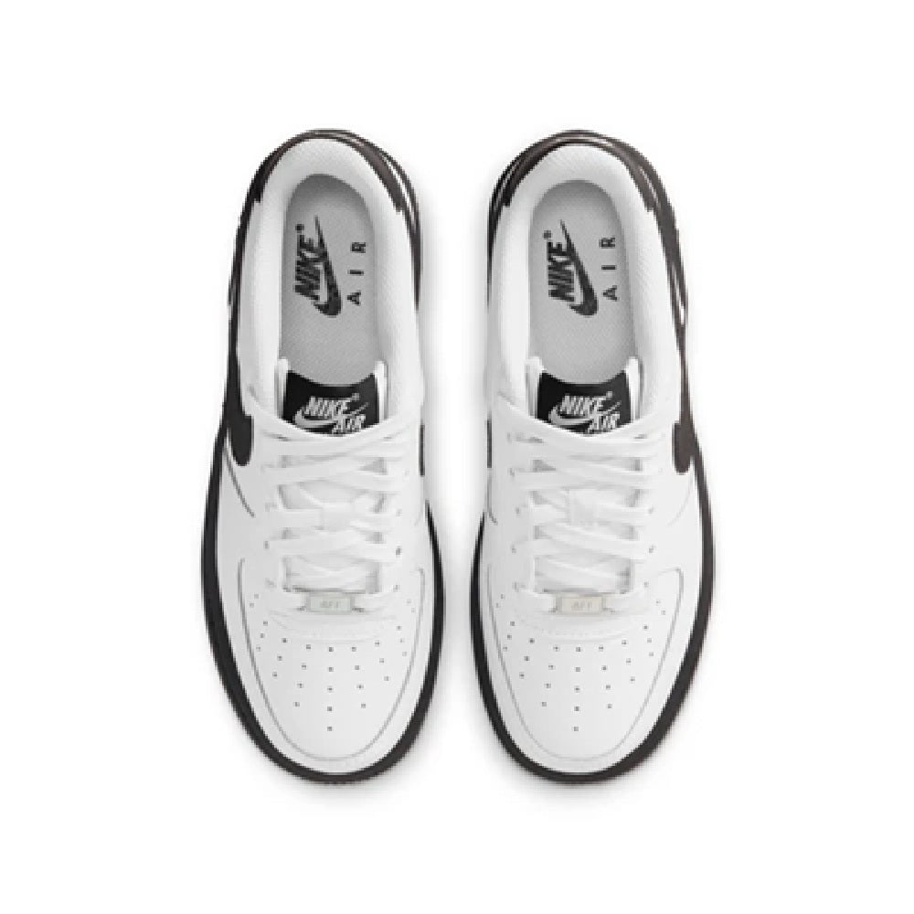 Kids' Nike Air Force 1 sneakers, white laces and toe with black-trimmed collar, top view.