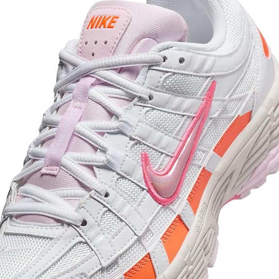 Nike women's P-6000 sneaker close-up with pink tongue, white laces, and orange trim
