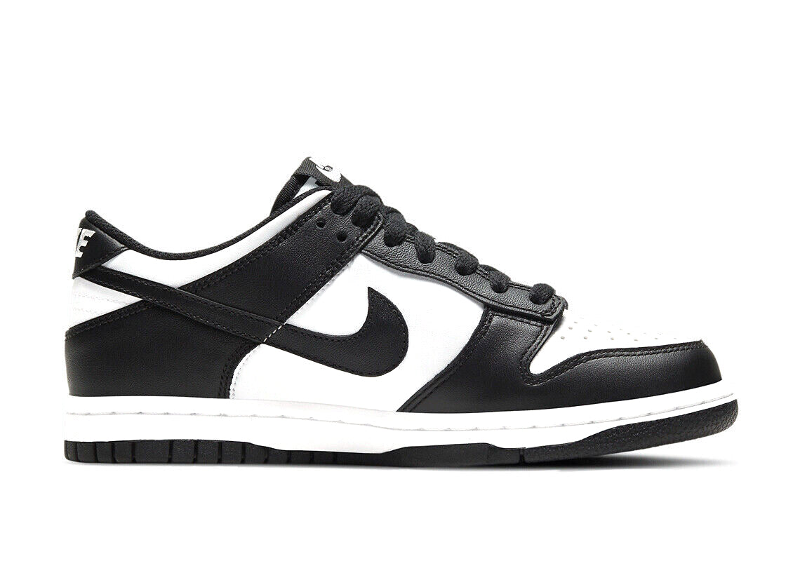 Black and white Nike Dunk Low sneakers, side view with Swoosh logo and padded collar