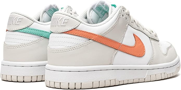 Kids' Nike Dunk Low sneakers pair, white with orange swoosh and turquoise lining