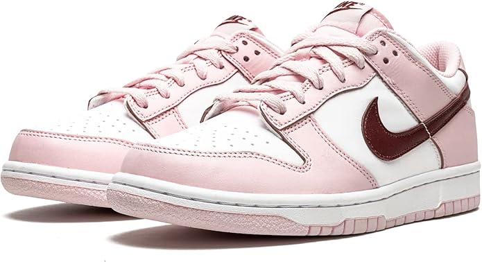 Pink and white low-top sneakers, front view, with dark maroon Swoosh and laces