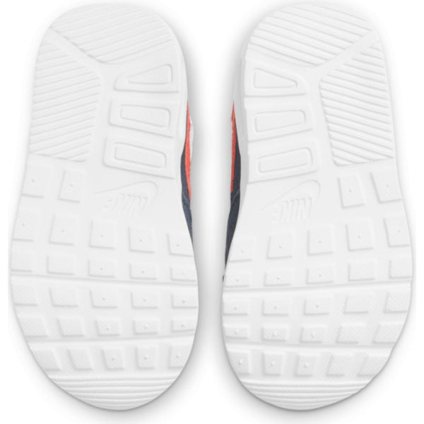 Kids' white sneaker outsoles with textured tread and small logo marks