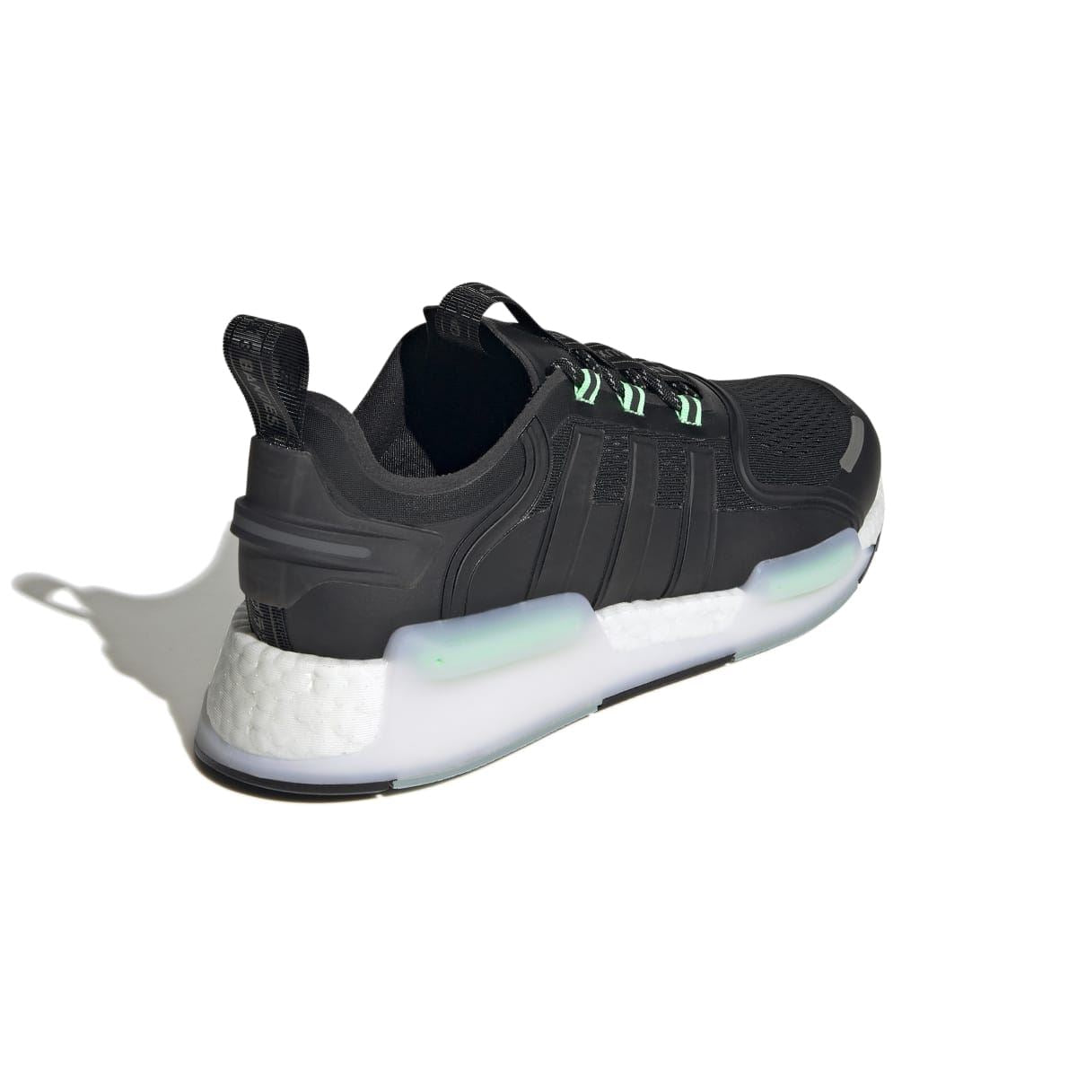 Black NMD_V3 heel view with green lace accents and white cushioned sole