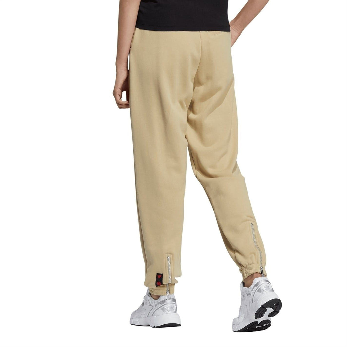 Beige tapered adidas Originals sweatpants with cuffed hem and side seam details