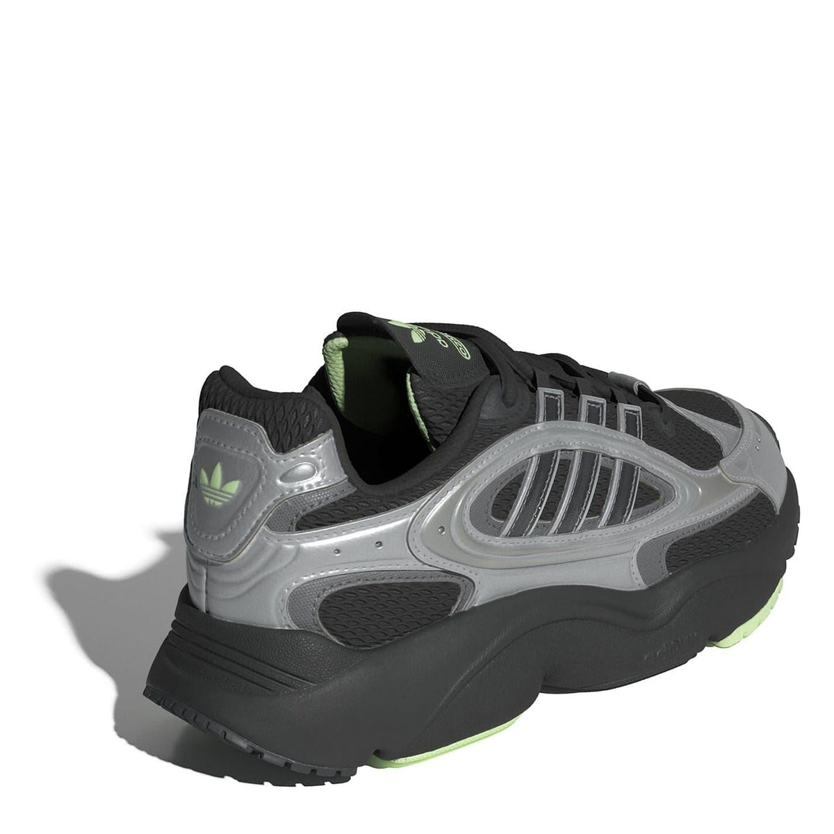 Low-top lace-up sneakers, silver-and-black upper with green-lined collar at the heel