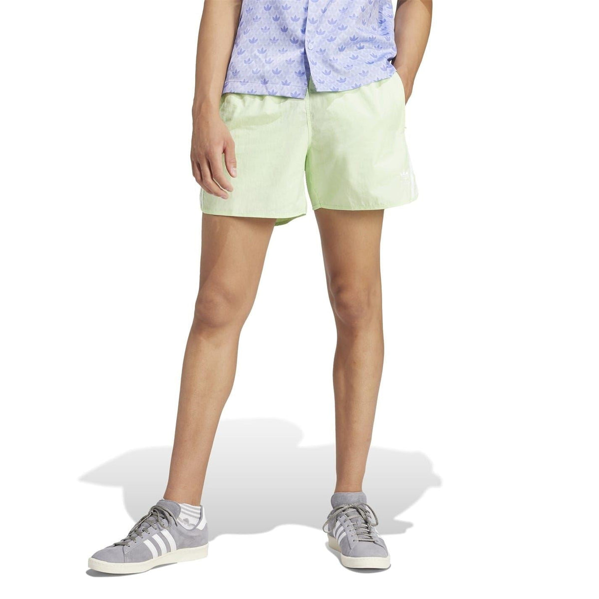 Light green bermuda shorts with elastic waistband and white side logo stripes